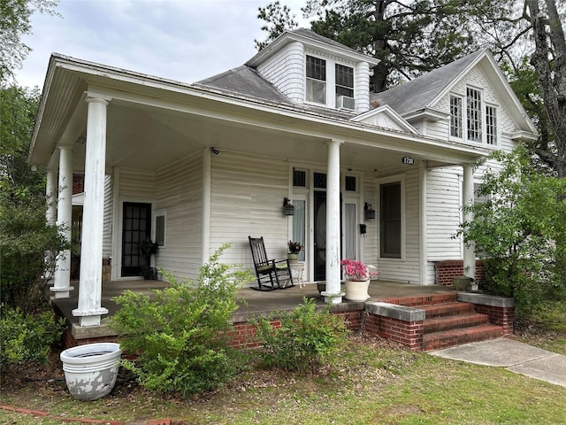 bungalow-style house featuring a porch and a shingled roof