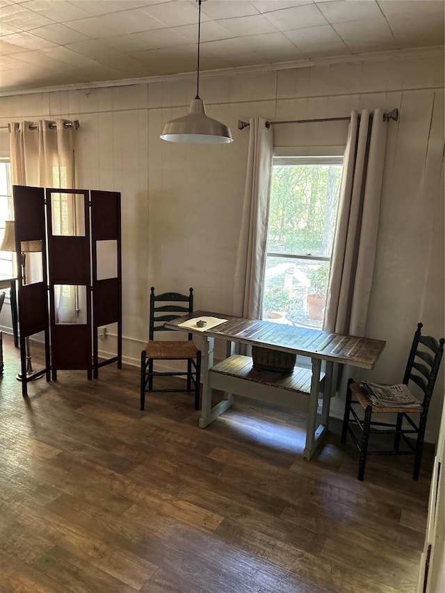 dining room with dark wood-type flooring and ornamental molding