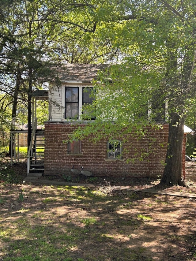 view of side of home with brick siding