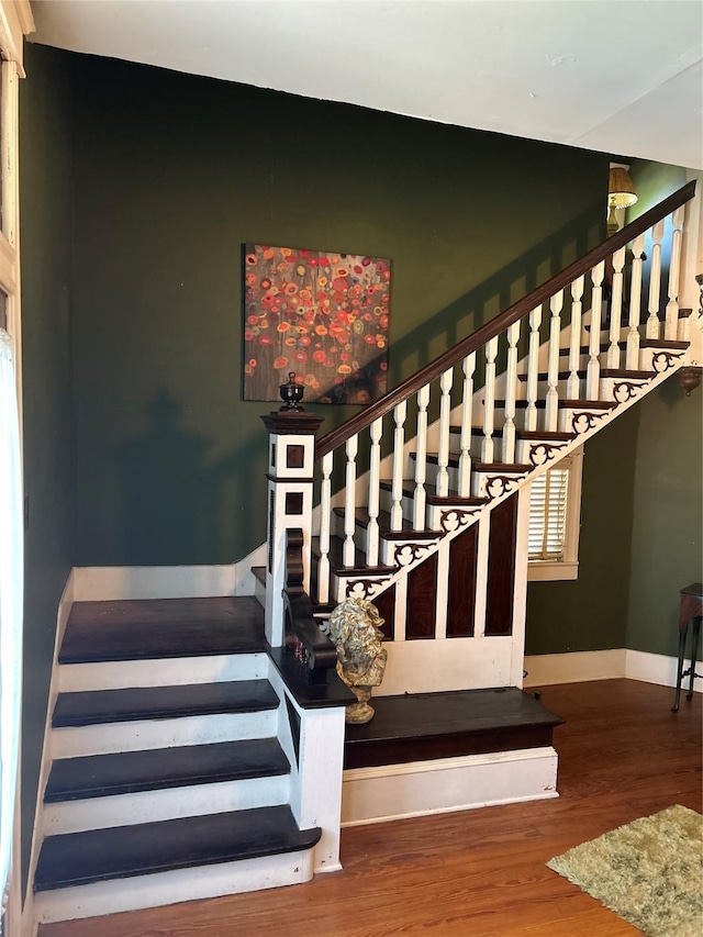 stairs with baseboards and wood finished floors