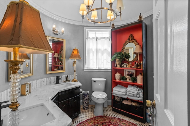 bathroom featuring crown molding, toilet, vanity, and an inviting chandelier