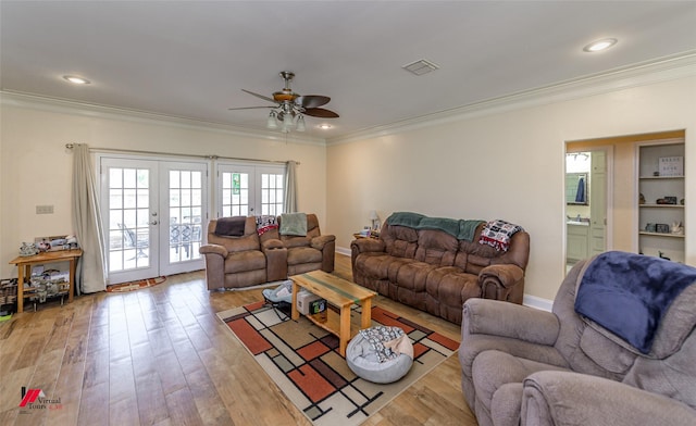 living area with a ceiling fan, light wood-style floors, french doors, ornamental molding, and recessed lighting