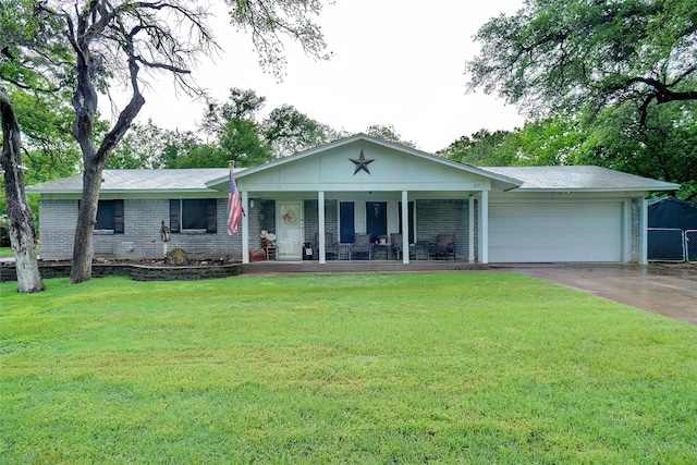 single story home with a porch, driveway, a garage, brick siding, and a front lawn