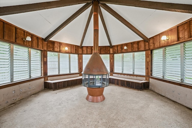 unfurnished sunroom featuring beam ceiling
