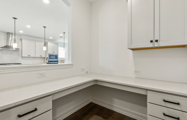 3470 Marginal Dr, Mckinney, TX 75071 - kitchen featuring wall chimney exhaust hood, dark wood-style flooring, stainless steel microwave, recessed lighting, and white cabinetry
