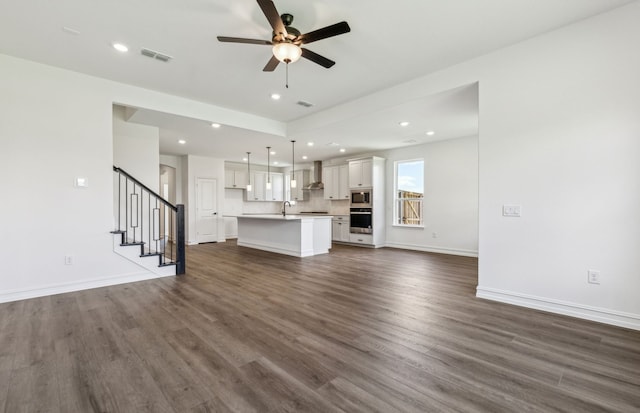 3470 Marginal Dr, Mckinney, TX 75071 - unfurnished living room with a ceiling fan, recessed lighting, dark wood-style floors, stairs, and baseboards