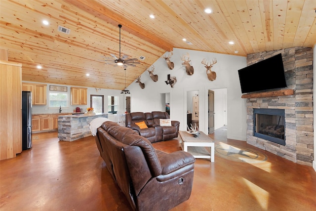living room with a stone fireplace, visible vents, wooden ceiling, and finished concrete floors