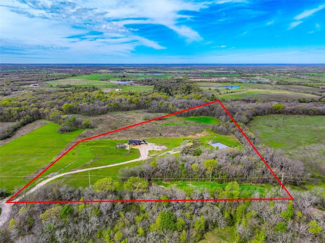 drone / aerial view featuring a rural view and a water view