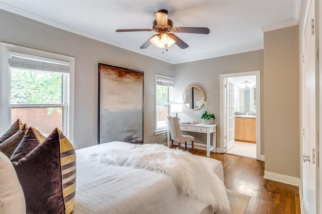 bedroom featuring baseboards, a ceiling fan, wood finished floors, ensuite bath, and ornamental molding