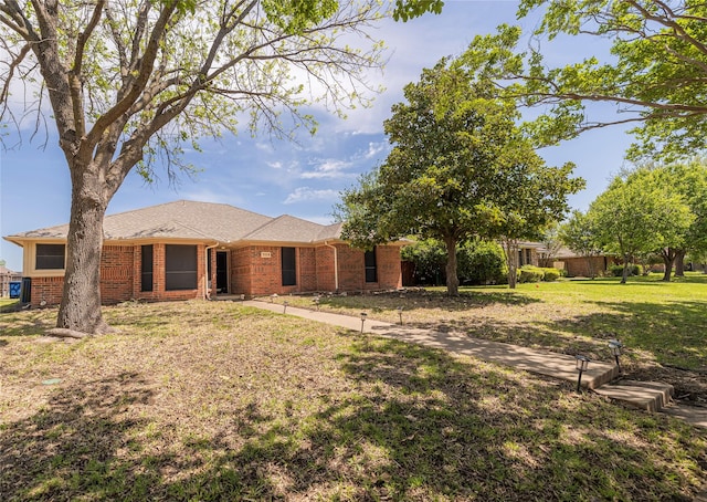 ranch-style home with brick siding and a front lawn