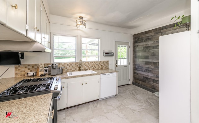kitchen featuring stainless steel range with gas cooktop, a sink, dishwasher, marble finish floor, and light countertops