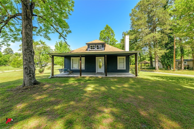 view of front facade with a front lawn and a chimney
