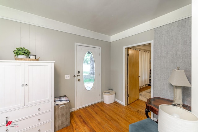 foyer entrance with baseboards and light wood-style flooring