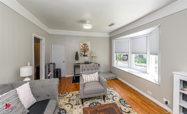 interior space with baseboards, wood finished floors, and visible vents
