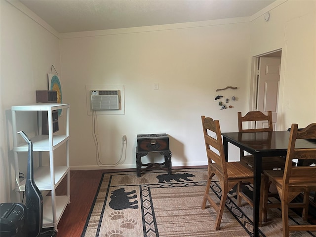 108 E Neely Ave, Comanche, TX 76442 - dining space with wood finished floors, an AC wall unit, and baseboards