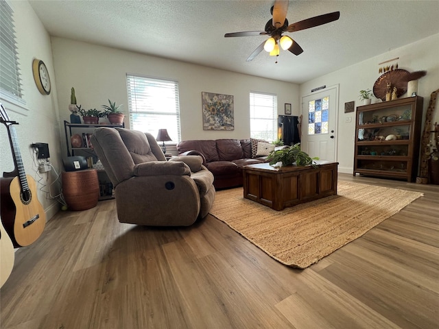 108 E Neely Ave, Comanche, TX 76442 - living room with a ceiling fan, a textured ceiling, and light wood-style floors