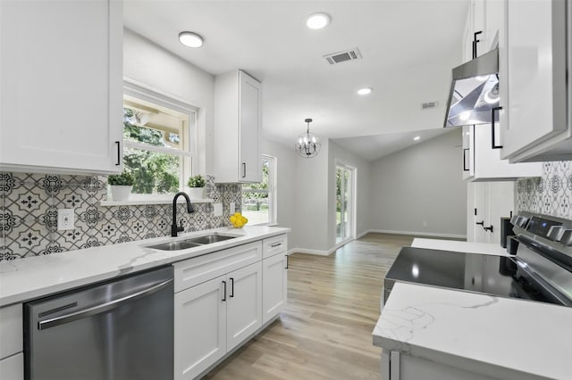 kitchen featuring white cabinets, stainless steel appliances, a sink, visible vents, and under cabinet range hood