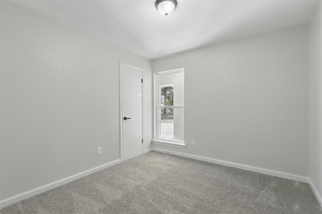 empty room with baseboards and carpet floors