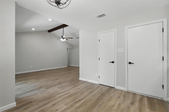 interior space featuring lofted ceiling with beams, ceiling fan, light wood finished floors, baseboards, and visible vents