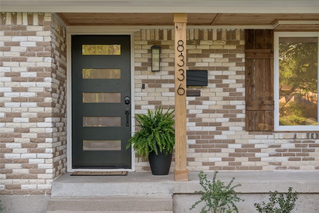 property entrance featuring brick siding and stone siding