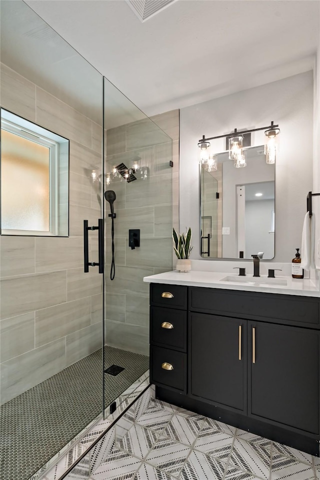 full bathroom featuring vanity, tile patterned flooring, and a stall shower