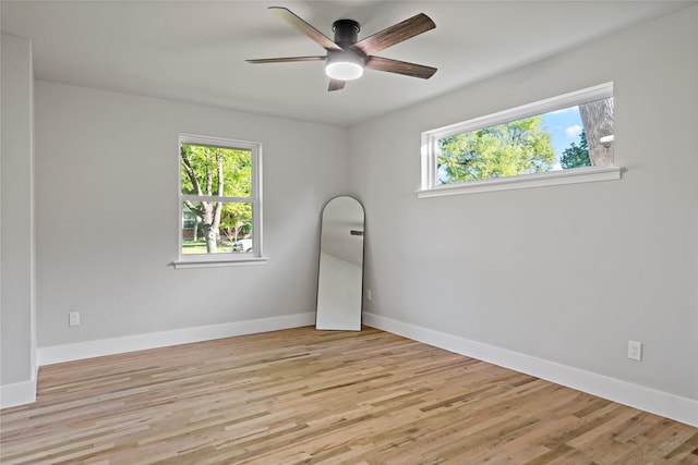 empty room featuring baseboards, light wood-style floors, and ceiling fan