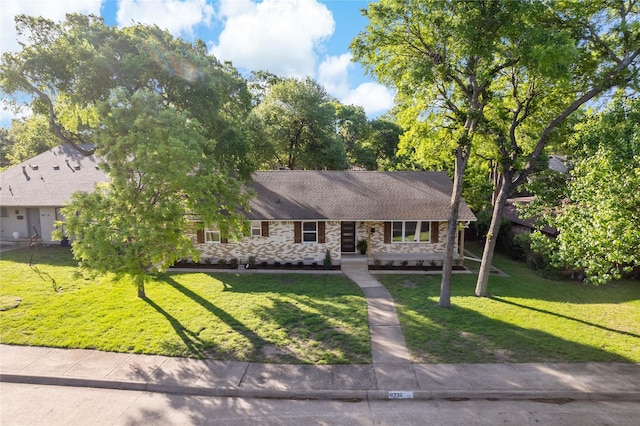 single story home featuring stone siding and a front lawn
