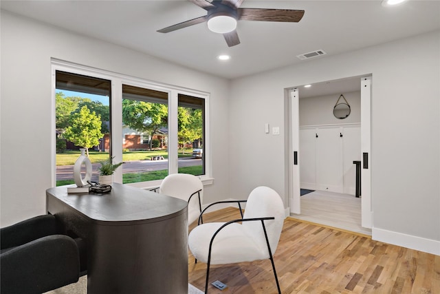 dining room featuring light wood finished floors, a ceiling fan, baseboards, and recessed lighting