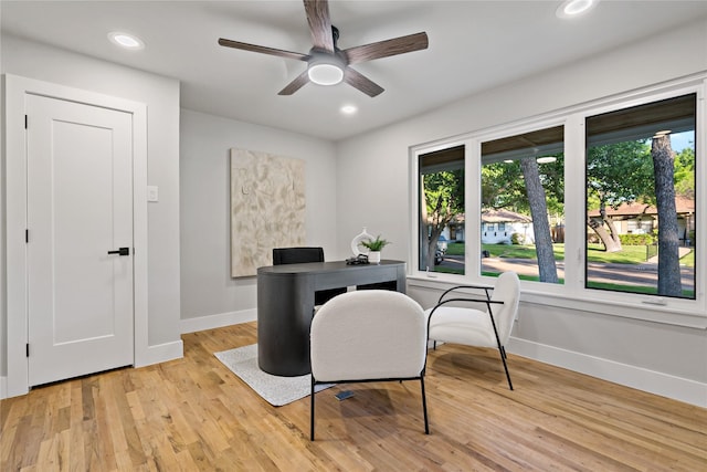 office space with baseboards, ceiling fan, and a healthy amount of sunlight