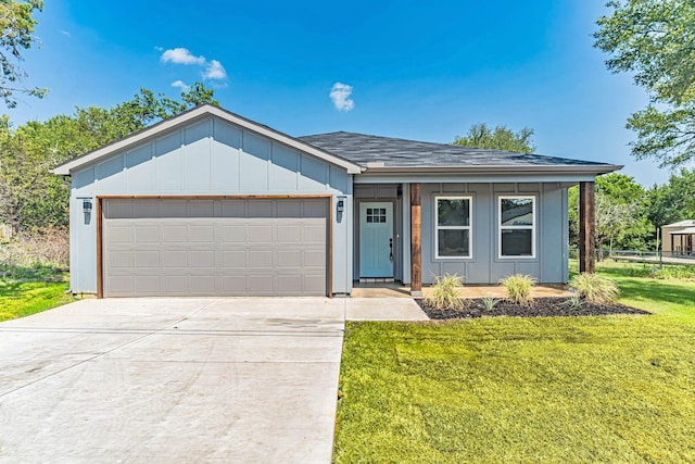 ranch-style house with roof with shingles, driveway, an attached garage, board and batten siding, and a front yard