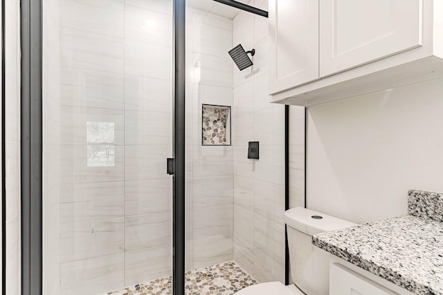 full bathroom with a shower stall and toilet
