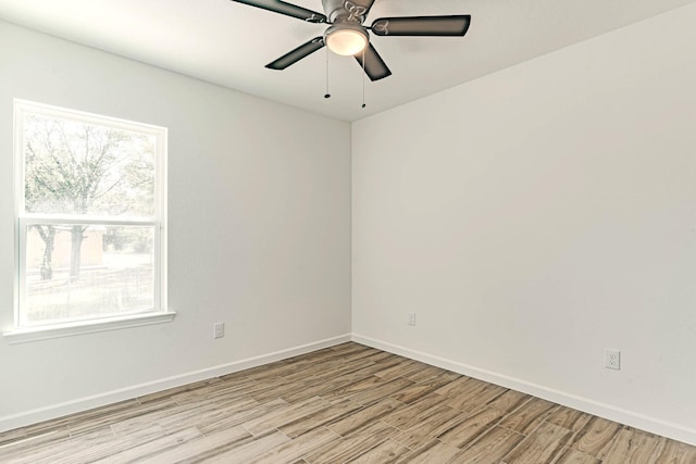 unfurnished room with ceiling fan, baseboards, and light wood-style floors