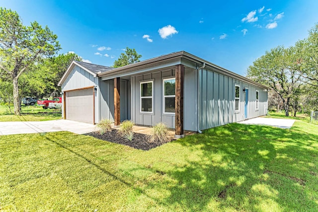 view of front of house featuring concrete driveway, an attached garage, board and batten siding, and a front yard