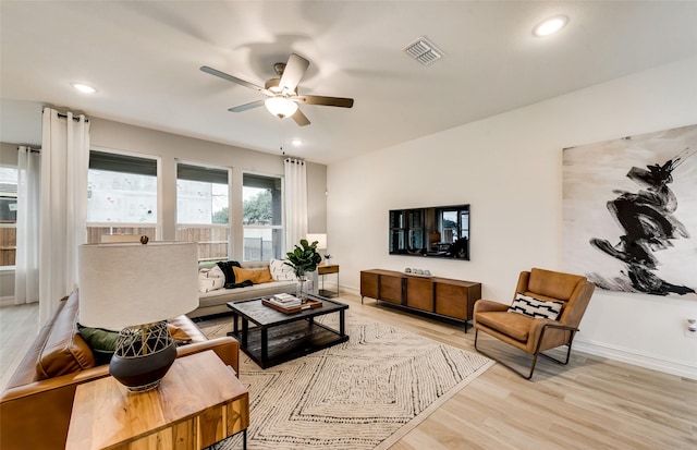 living area with recessed lighting, light wood finished floors, visible vents, a ceiling fan, and baseboards