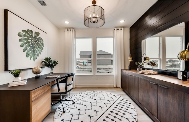 office space featuring recessed lighting, visible vents, baseboards, light wood-style flooring, and a notable chandelier