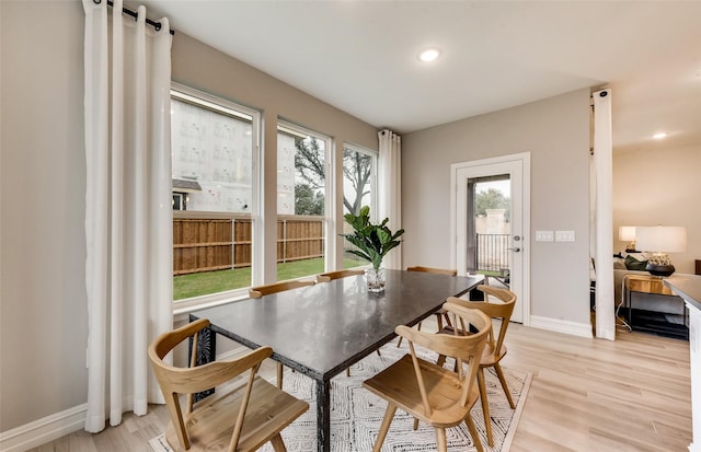 dining space with baseboards, recessed lighting, and light wood-style floors