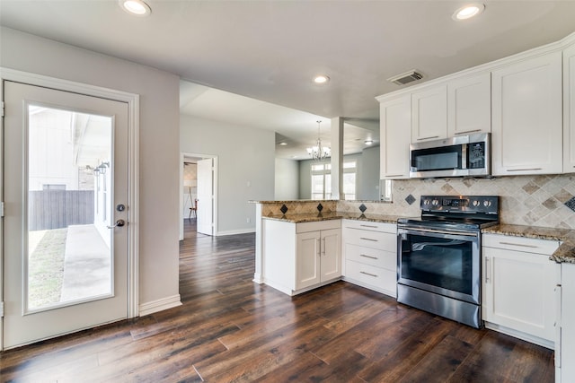 kitchen featuring a sink, stainless steel dishwasher, a peninsula, and dark wood-type flooring