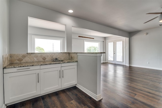 kitchen featuring stainless steel microwave, dark wood-style flooring, white cabinetry, and visible vents