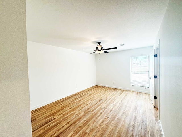 2408 Miller St, Denison, TX 75020 - empty room featuring ceiling fan, baseboards, light wood finished floors, and visible vents