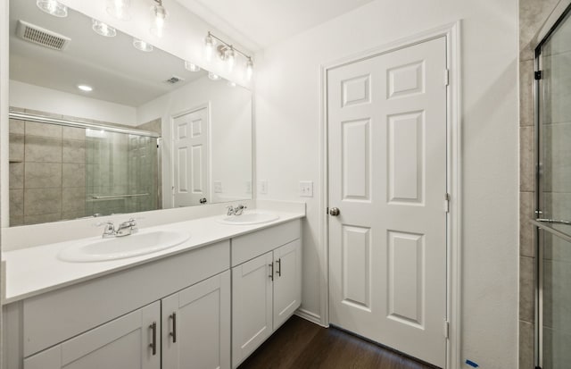 7108 Pederson Creek Way, Denton, TX 76208 - full bathroom featuring a shower stall, double vanity, and wood finished floors