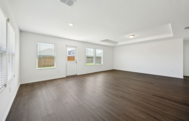 7108 Pederson Creek Way, Denton, TX 76208 - unfurnished living room featuring a tray ceiling, dark wood-type flooring, baseboards, and recessed lighting