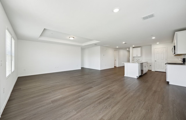 7108 Pederson Creek Way, Denton, TX 76208 - unfurnished living room featuring a tray ceiling, recessed lighting, baseboards, and dark wood-style flooring
