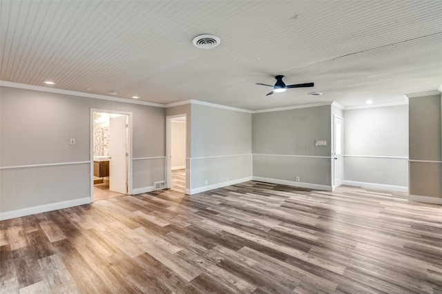 empty room featuring recessed lighting, wood finished floors, visible vents, and crown molding