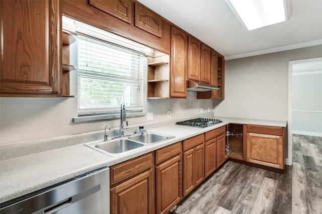 kitchen featuring dark wood-style flooring, open shelves, a sink, stainless steel appliances, and ornamental molding