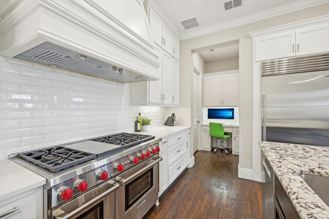 kitchen featuring a notable chandelier, appliances with stainless steel finishes, a sink, a glass covered fireplace, and visible vents