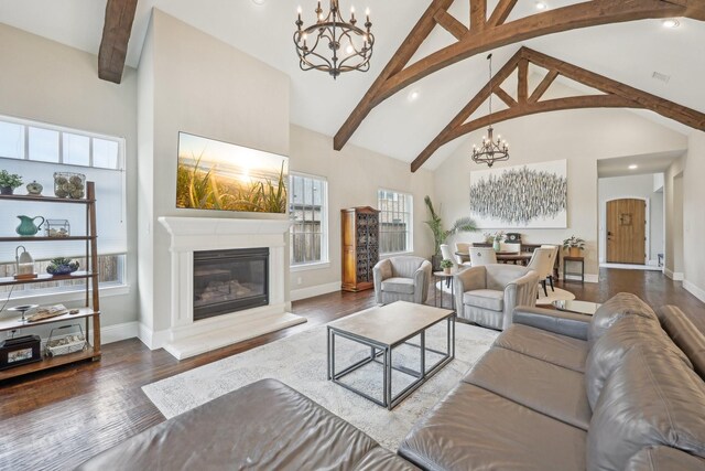 living area featuring baseboards, high vaulted ceiling, and wood finished floors