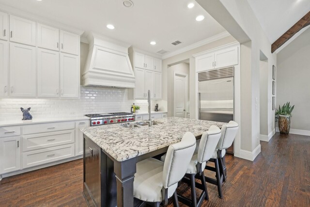 dining space featuring baseboards, wood finished floors, and vaulted ceiling with beams