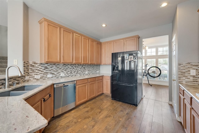 113 Bob White Ct, Rockwall, TX 75087 - kitchen featuring a sink, backsplash, black fridge with ice dispenser, wood finished floors, and dishwasher