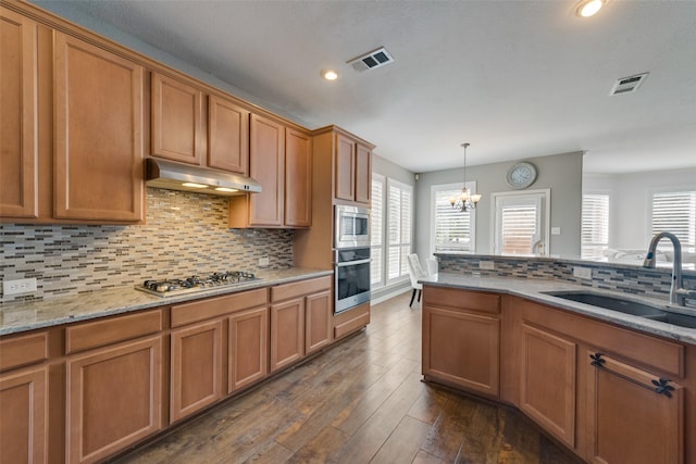 113 Bob White Ct, Rockwall, TX 75087 - kitchen with visible vents, stainless steel appliances, under cabinet range hood, and a sink