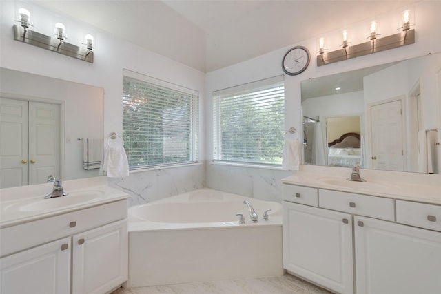 113 Bob White Ct, Rockwall, TX 75087 - ensuite bathroom with two vanities, a garden tub, and a sink